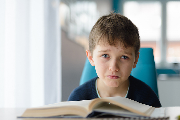 Struggling reader, boy with book